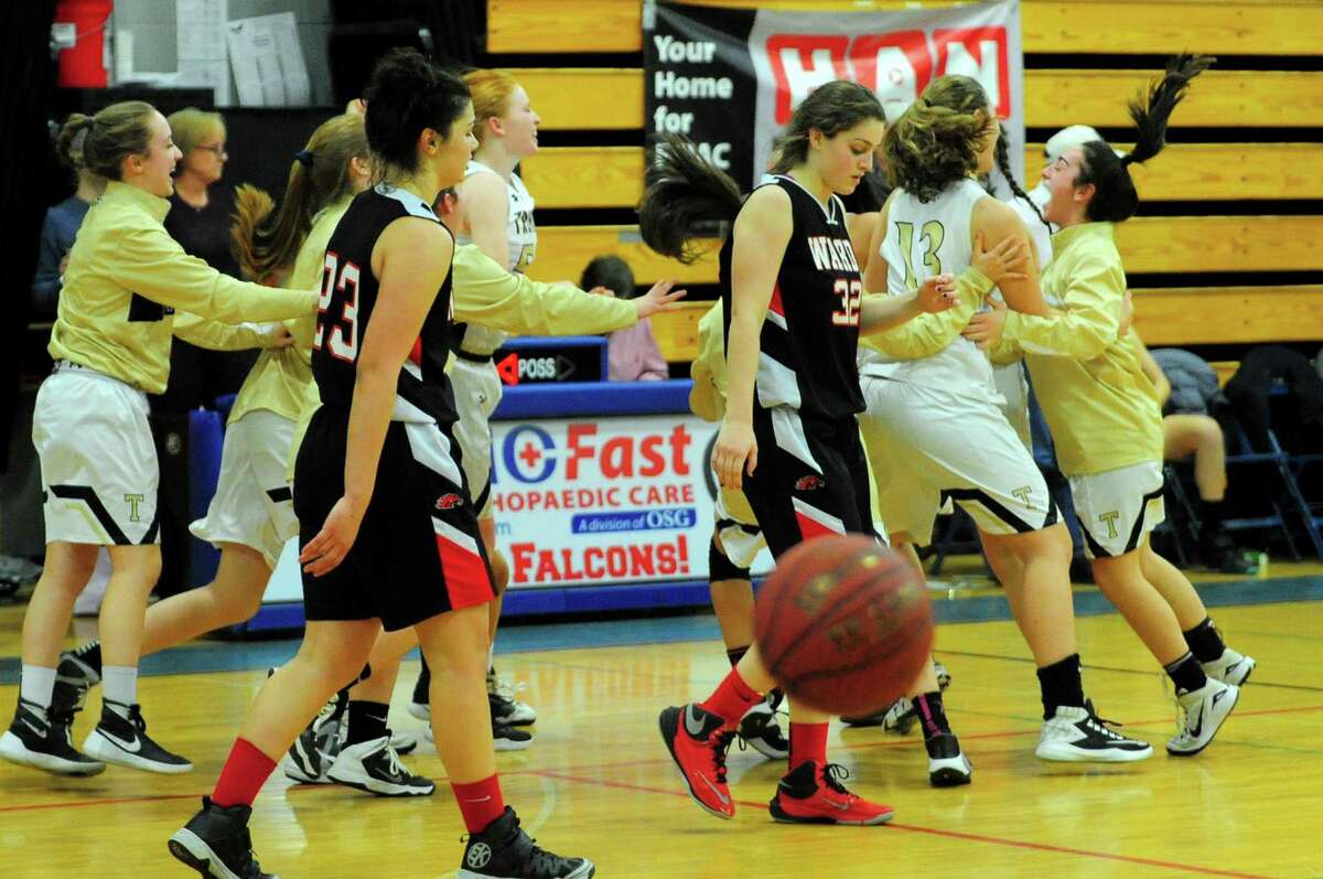Trumbull teammates rush onto the court to celebrate after beating Fairfield Warde during FCIAC Girls Basketball Semi-final action in Fairfield, Conn., on Tuesday Feb. 21, 2017.