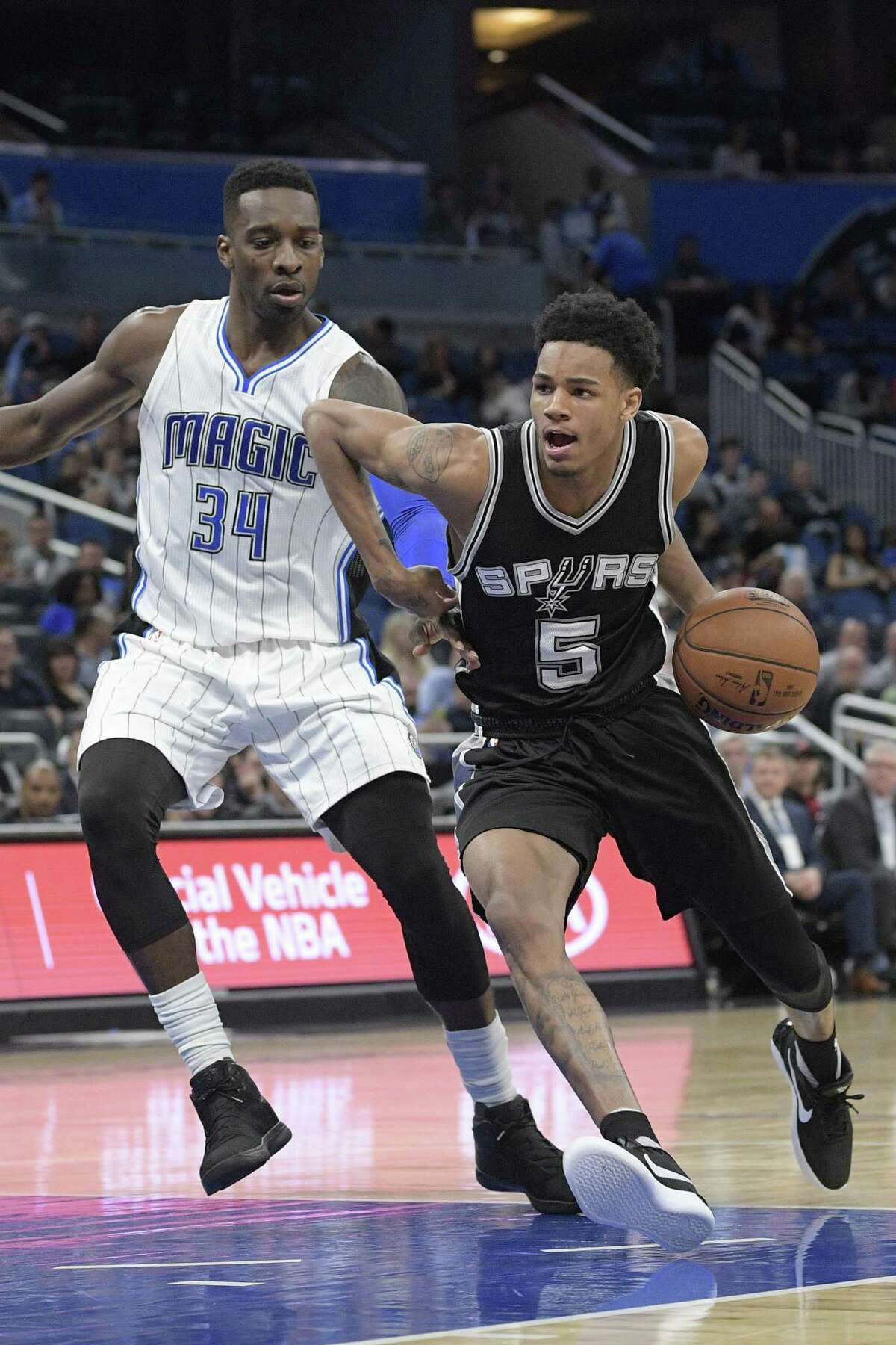 San Antonio Spurs guard Dejounte Murray (5) drives to the basket in front of Orlando Magic forward Jeff Green (34) during the second half of an NBA basketball game in Orlando, Fla., Wednesday, Feb. 15, 2017. The Spurs won 107-79. (AP Photo/Phelan M. Ebenhack)