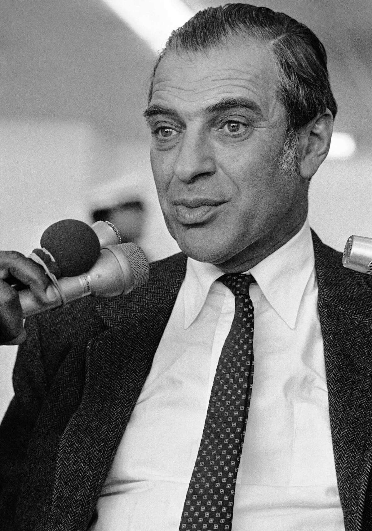 Prof. Kenneth Arrow talks to newmen after his arrival in San Francisco airport, Oct. 24, 1972. Arrow, a Harvard economist, was named a co-winner of the Nobel prize in economics. (AP Photo/Lennox McLendon)