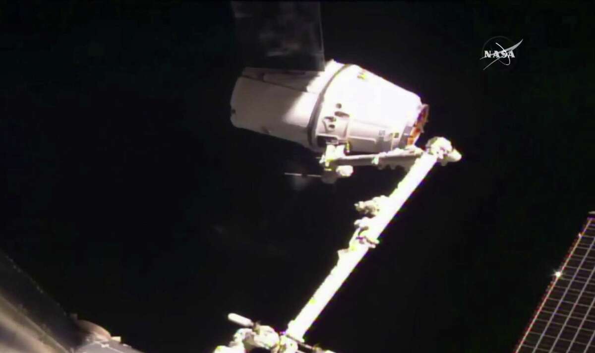 SpaceX's Dragon cargo ship is captured Thursday by astronauts on the International Space Station.