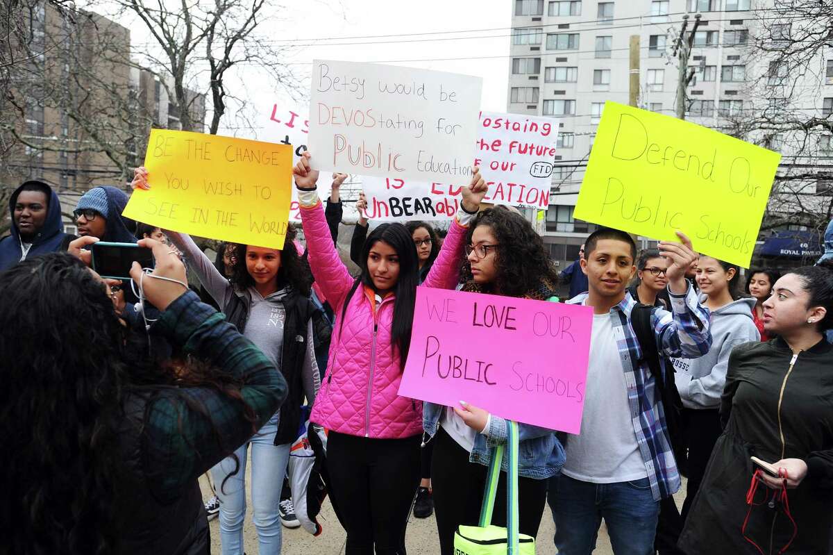 Stamford High School students (L-R) Fanny Cabrera, Jasmin Rodriguez, Veronica DeLeon and Chris Lopez hold signs while outside of Stamford High School during a walkout to protest the new U.S. Secretary of Education Betsy DeVos in Stamford, Conn. on Thursday, Feb. 23, 2017.