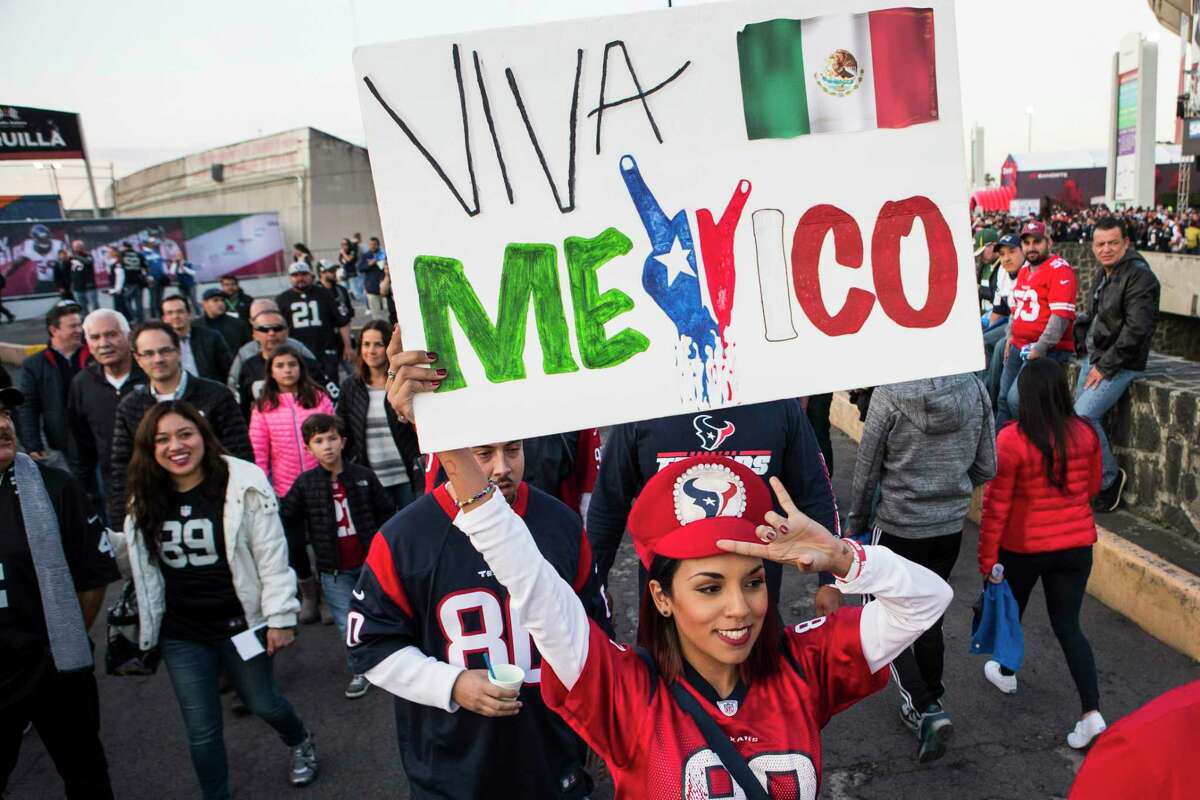 Houston Texans fans walk into the stadium before an NFL football game between the Houston Texans and the Oakland Raiders at Estadio Azteca on Monday, Nov. 21, 2016, in Mexico City.