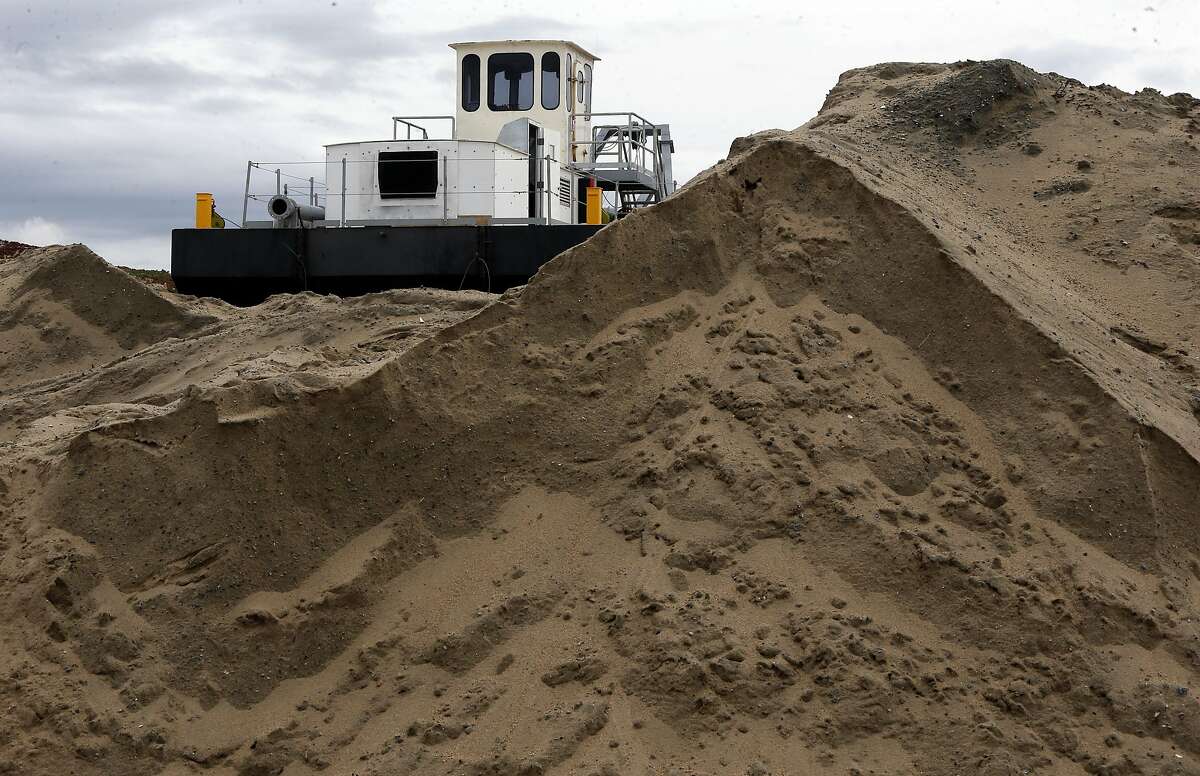 A dredge owned by Cemex sits atop a berm along the Monterey Bay coastline in Marina, Ca., as seen on Wednesday Feb. 8, 2017. The Cemex Lapis Plant removes more than 200,000 acre feet of beach sand a year.