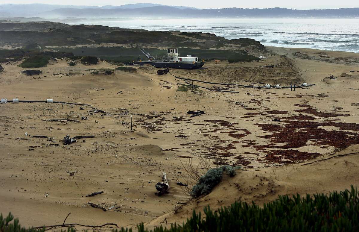 A dredge owned by Cemex sits at the edge of a berm near where it collects beach sand along the Monterey Bay coastline in Marina, Ca., as seen on Wednesday Feb. 8, 2017. The Lapis Plant removes more than 200,000 acre feet of beach sand a year.