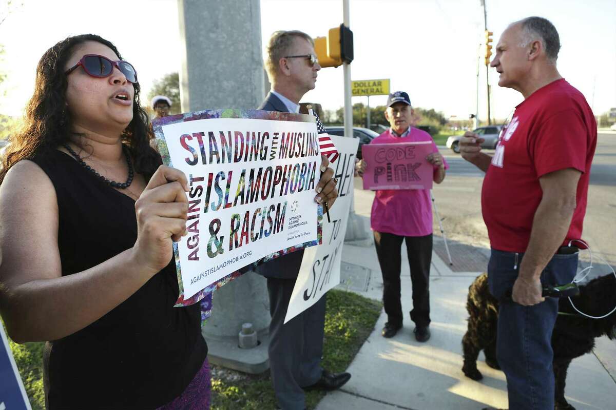 Siri Gurubhagavathula (left) and others protest a meeting held by ACT for America at Village Parkway Baptist Church.