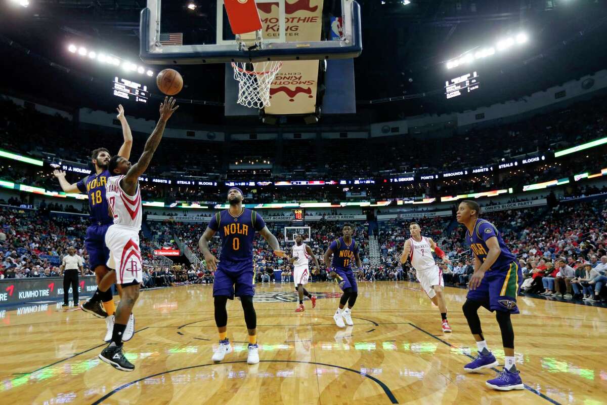 The two new guys made quite a splash in their Thursday night debuts in new uniforms. The Rockets' Lou Williams splits the Pelicans' defense for two of his team-high 27 points, while DeMarcus Cousins, right, looks on. Cousins had 27 points and 14 boards.