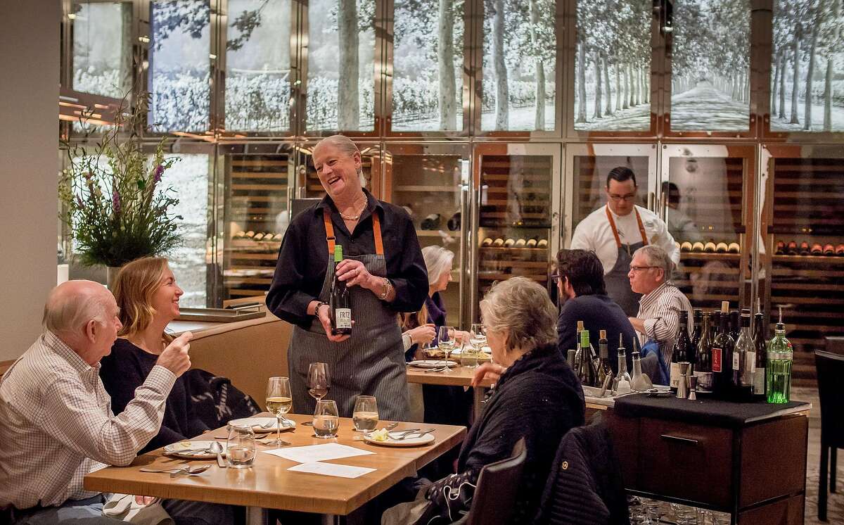 Server Lillian Wiggins offers wine to diners at CIA at Copia in Napa, Calif. on February 23rd, 2017.