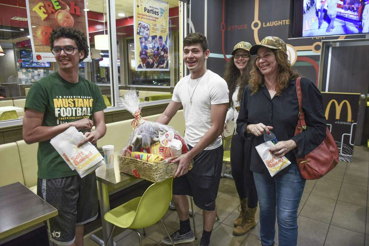McMonday raffle winner Jorge Murillo holds a basket as he stands with Rudy Garza, Isella Murillo and Leticia Murillo on Thursday at McDonald's Jacaman Road location during the announcement of the McMonday raffle winner.