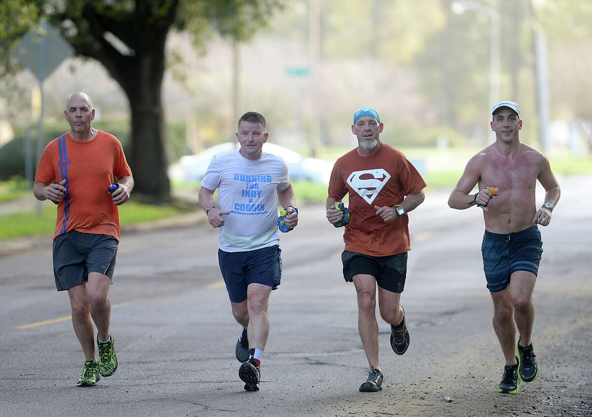 Runners Ike Adams (center, right) and Dave Jones (center, left) join with Brian Bauer (far left) and Joe Huyett (far right) as they train for this year's Gusher Marathon with an 18-mile run Saturday morning. The pair will team up again later this spring when they head north to take part in the Boston Marathon. Adams and Jones are pairing their love of running with a cause near and dear to their hearts, "Running for a Purpose" to raise funds for The Cure Starts Now Foundation. Photo taken Saturday, February 18, 2017 Kim Brent/The Enterprise