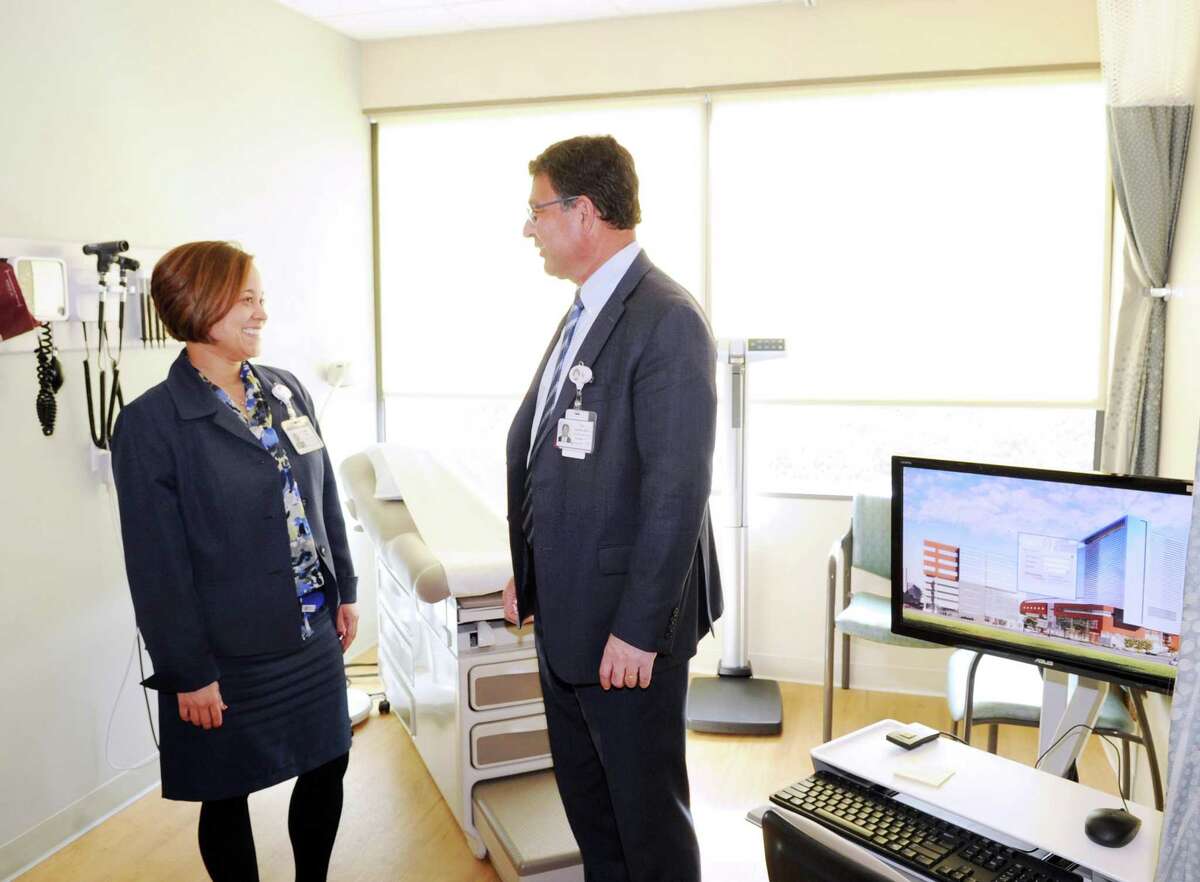 At left, Lisette Torres, Stamford Medical Group administrator, left, speaks with Dr. Rod Acosta, president and chief executive officer of Stamford Medical Group in a patient examination room in the Walk In Center at the Stamford Health Medical Group, Stamford Hospital's outpatient center in Stamford, Conn., Tuesday, Feb. 21, 2017. The facility located at 292 Long Ridge Road houses doctors focusing on primary care, cardiology, endocrinology, neurology, obstetrics, gynecology and orthopedics, as well as diagnostic imaging labs and a walk-in center.
