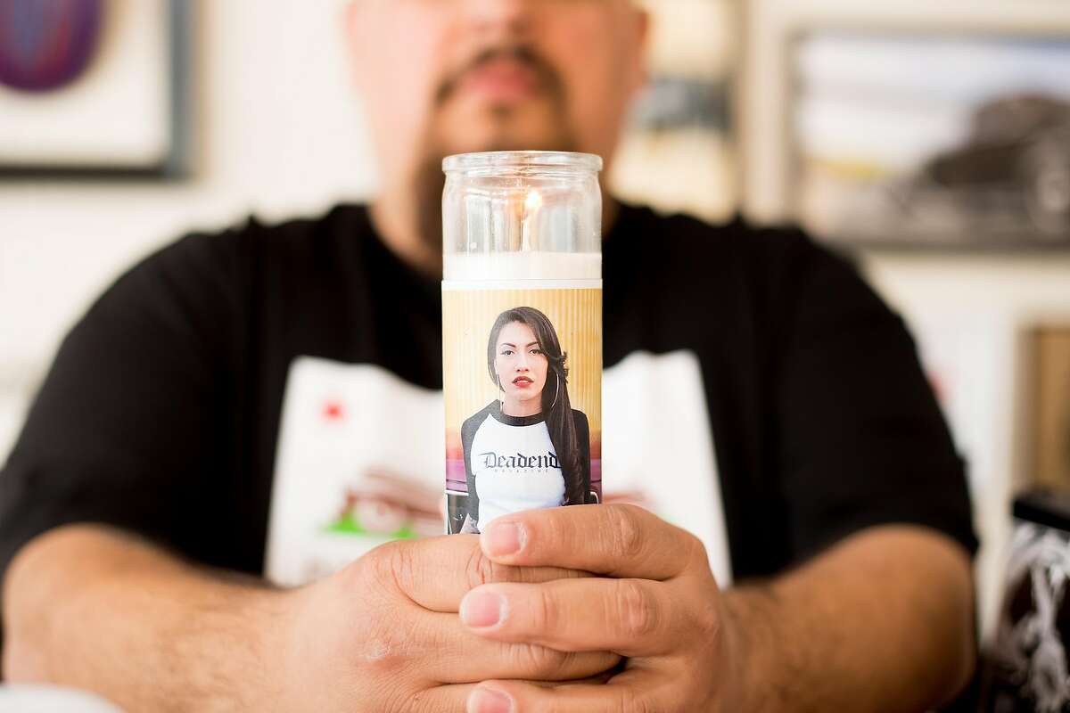Juan Espinoza displays a Deadend prayer candle in his Salinas, Calif., store on Sunday, Feb. 19, 2017.
