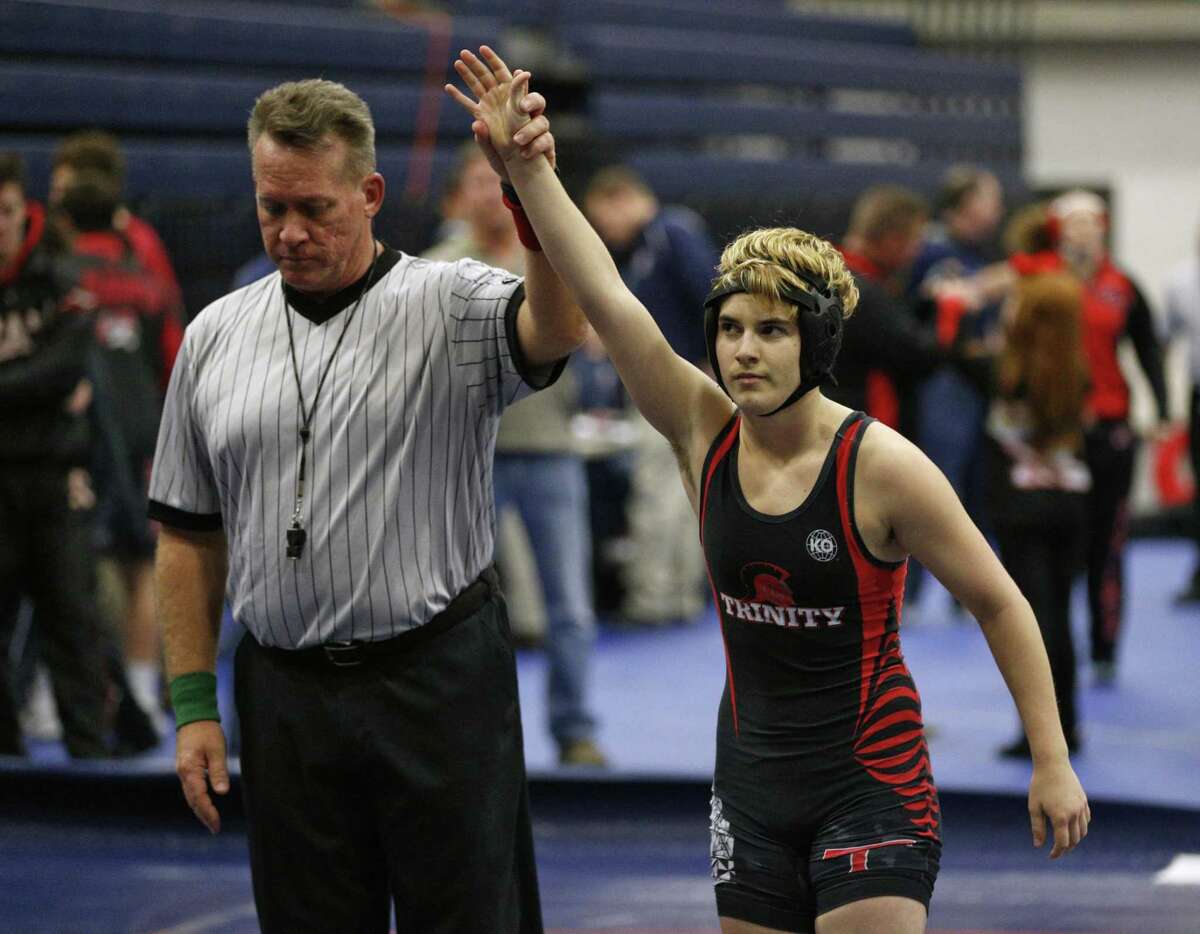 In this Feb. 18, 2017 photo, Euless Trinity's Mack Beggs is announced as the winner of a semifinal match after Beggs pinned Grand Prairie's Kailyn Clay during the finals of the UIL Region 2-6A wrestling tournament at Allen High School in Allen, Texas. Beggs, who is transgender, is transitioning from female to male, won the girls regional championship after a female opponent forfeited the match. (Nathan Hunsinger/The Dallas Morning News via AP)