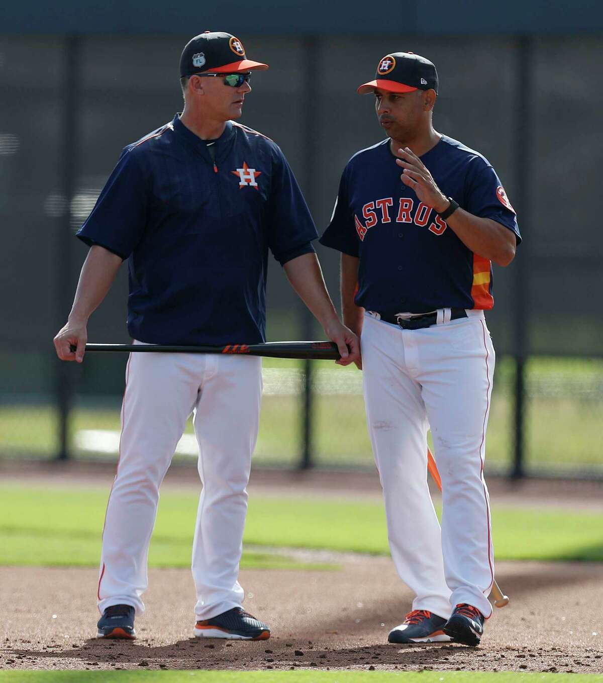 Houston Astros manager A.J. Hinch and bench coach Alex Cora talk during spring training at The Ballpark of the Palm Beaches, in West Palm Beach, Florida, Friday, February 24, 2017.