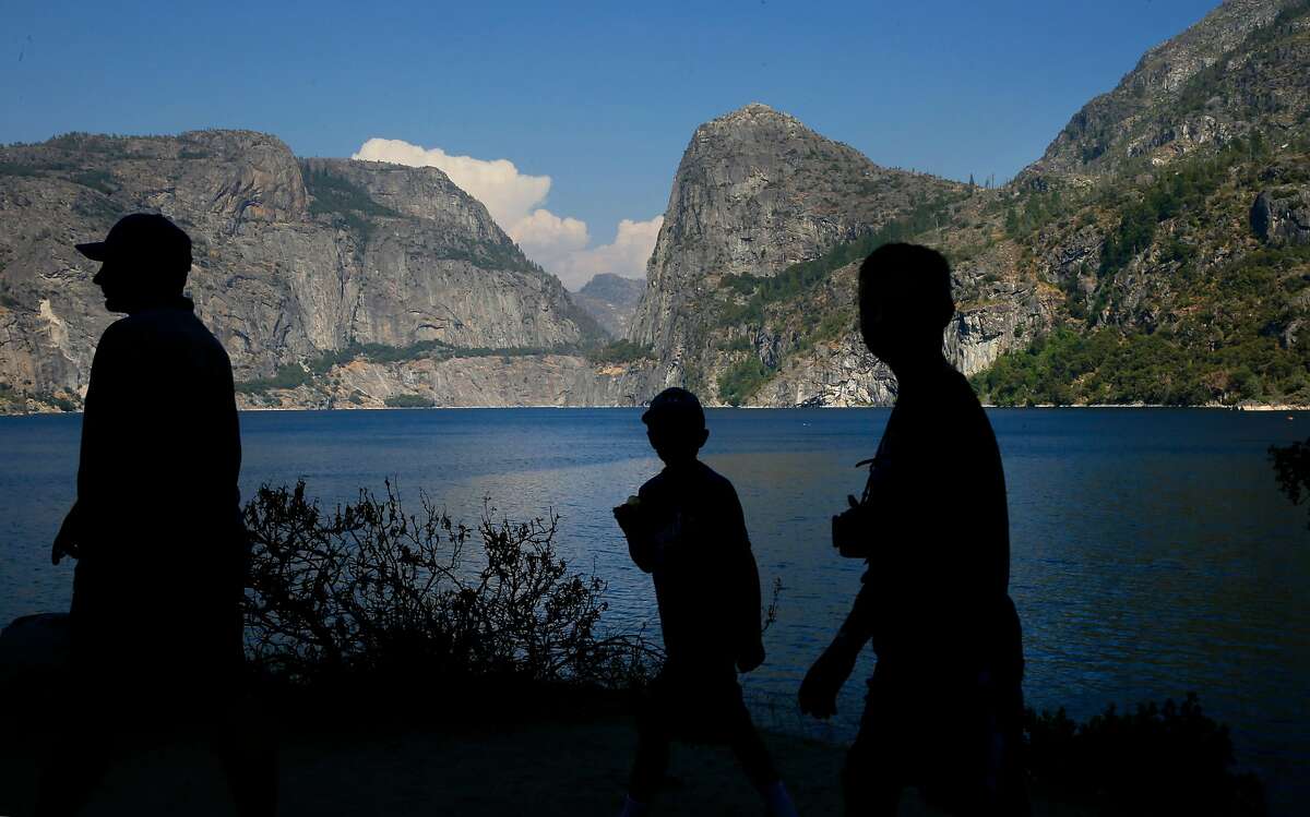 Visitors explore the shoreline of Hetch Hetchy reservoir in Yosemite National Park, California, on Thurs. July 28, 2016. Mountain Tunnel, a key piece of the Hetch Hetchy water system is at risk of collapse, so this summer, the San Francisco Public Utilities Commission is preparing to repair the 19-mile-long tunnel just outside of Yosemite in a steep, hard-to-access wilderness area.