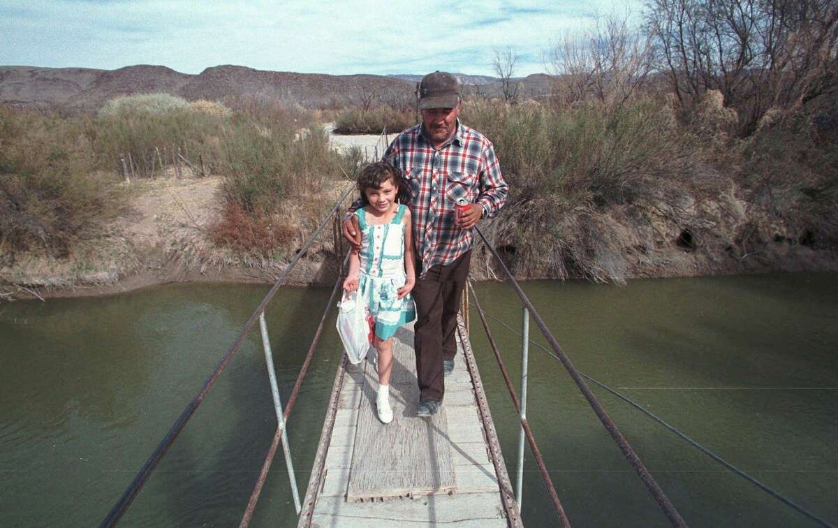 Once upon a time — this photo is from 1998 — there was a bridge that crossed the Rio Grande and connected Candelaria, Texas to San Antonio Del Bravo in Mexico. It’s the one Maria Evagelina Garza and her grandfather Vicente dela O crossed in this February 1998 file photo. It no longer exists, thanks to our panic over border security.