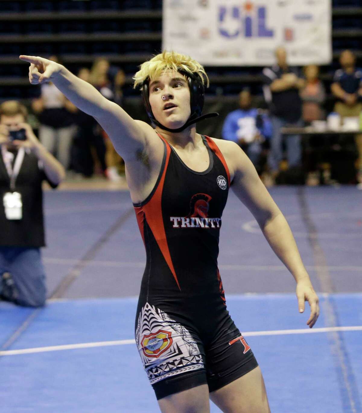 Mack Beggs, top, a transgender wrestler from Euless Trinity High School, celebrates victory over Mya Engert of Amarillo Tascosa in a quarterfinals match in the State Wrestling Tournament at Berry Center, 8877 Barker Cypress Road, Friday, Feb. 24, 2017, in Cypress. Beggs was born a girl and is transitioning to male but wrestles in the girls division.
