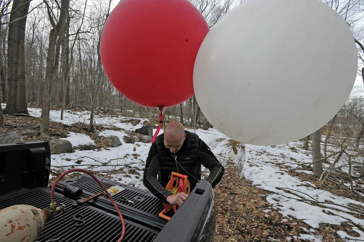 Phil Rydel of All-Points Technology, a consulting firm out of Killingworth, Conn. inflates a balloon on Feb. 21, 2017. The town of New Canaan is conducted a balloon test in the area where a communications tower will be built on property owned by Aquarion at the Laurel Reservoir in North Stamford. The information gathered about the sight lines from the balloon test will be reviewed and presented at a public town meeting.