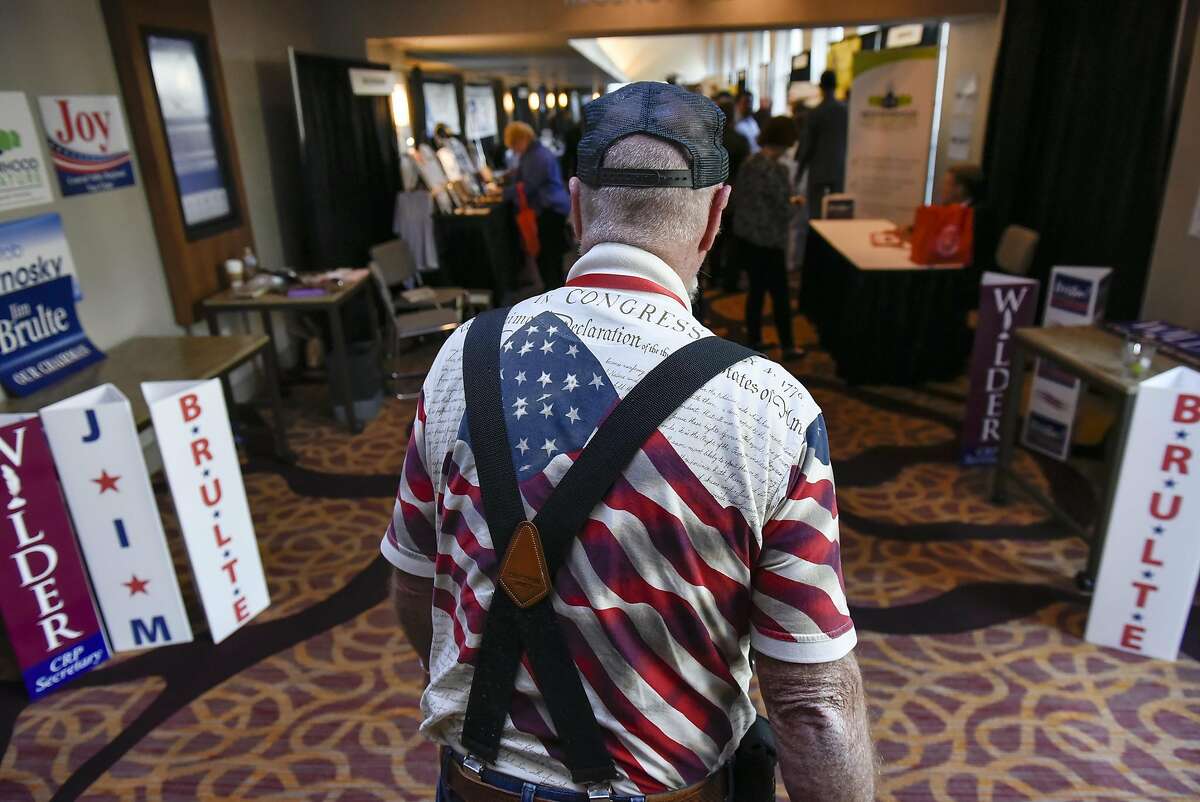 Tea Party member Chris Ivey of Paso Robles wears an American flag shirt as he walks down a hallway during the California Republican Party's 2017 Organizing Convention in Sacramento, CA, on Friday February 24, 2017.