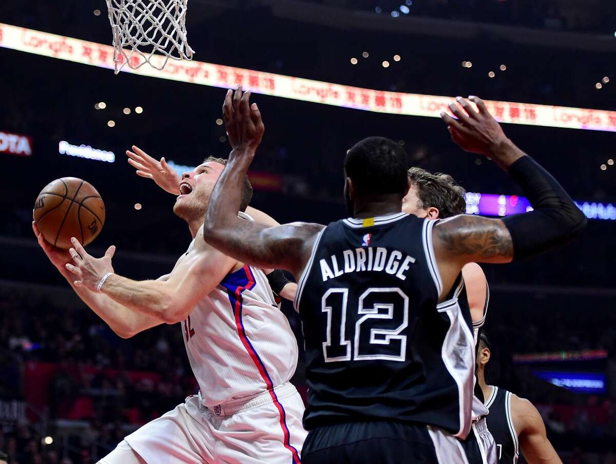 LOS ANGELES, CA - FEBRUARY 24: Blake Griffin #32 of the LA Clippers scores on a layup past LaMarcus Aldridge #12 and Pau Gasol #16 of the San Antonio Spurs during the first half at Staples Center on February 24, 2017 in Los Angeles, California. NOTE TO USER: User expressly acknowledges and agrees that, by downloading and or using this photograph, User is consenting to the terms and conditions of the Getty Images License Agreement. (Photo by Harry How/Getty Images)