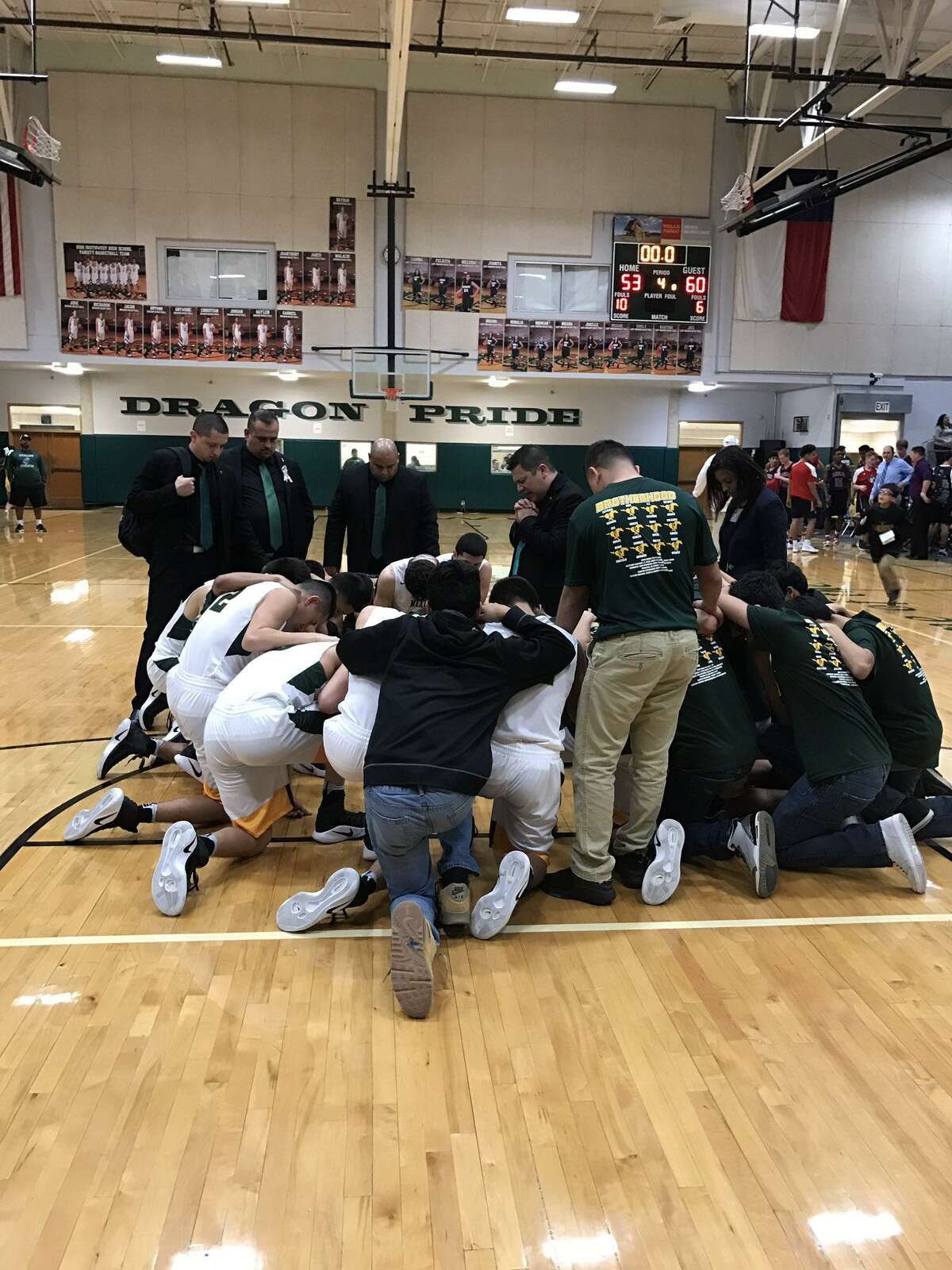 Nixon players react at San Antonio Southwest High School after being eliminated in the second round of the playoffs by CC Veterans Memorial 60-53. The Mustangs had won in the area round the past two seasons.