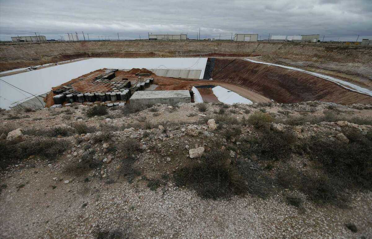 Hundreds of heavy metal casks containing low-level nuclear waste is seen capped by concrete and then layered with Dockum — a clay unique to the area at Waste Control Specialists (WCS) near Andrews, Texas on Feb. 14, 2017. A move to store more nuclear waste at the site has prompted concerns in San Antonio and elsewhere on the routes this waste would take to the site.