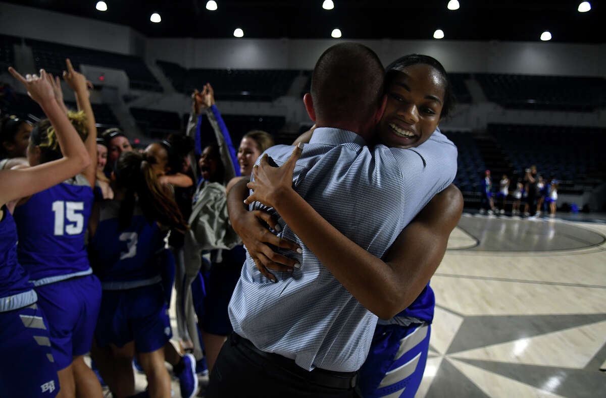 Barbers Hill junior post Charli Collier, right, shares a hug with Head Coach Tri Danley after the Lady Eagle's 55-43 win over Georgetown in the Region III-5A Girls Basketball Championship game at Delmar Fieldhouse in Houston on Saturday. (Photo by Jerry Baker/Freelance)