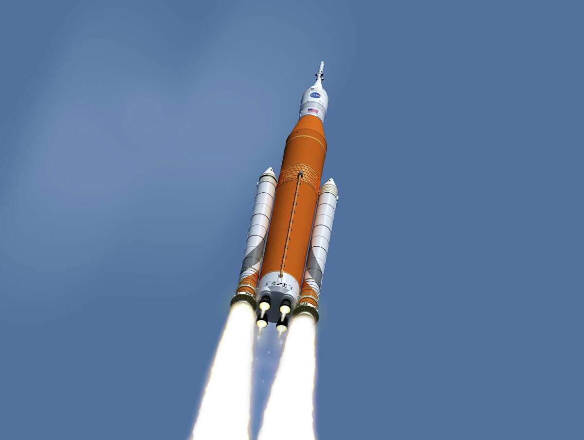 This image made available on Feb. 15, 2017 by NASA shows an artist's concept of the launch of the Space Launch System rocket and Orion capsule. On Friday, Feb. 24, 2017, NASA said it is weighing the risk of adding astronauts to the first flight of its new megarocket. (NASA/Marshall Space Flight Center via AP)