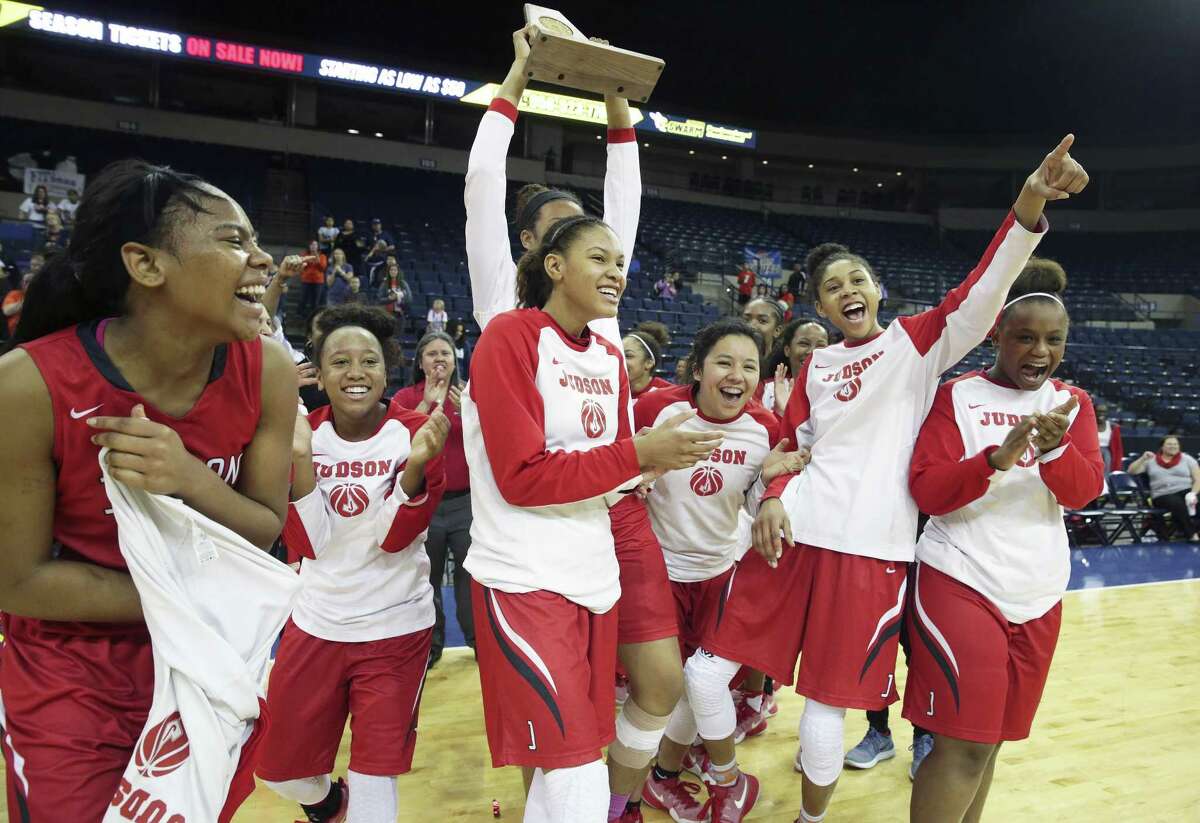 The Rockets celebrate with the trophy as Judson beats Brandeis at the Laredo Energy Arena in the Region IV-6A final of girls basketball on Feb. 25, 2017.