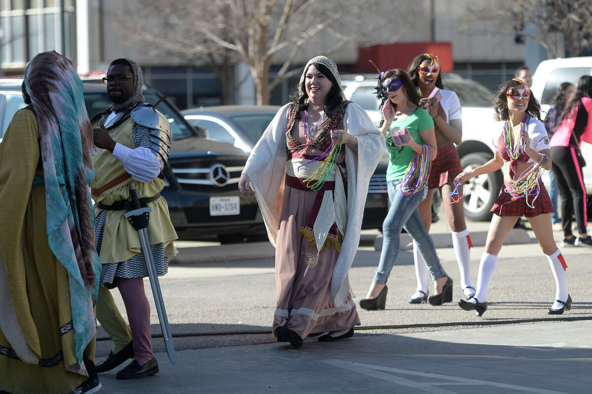 Parade participants stroll downtown before the start of a crawfish boil to kick off a weekend of Mardi Gras festivities on Saturday, Feb. 25, 2017, in downtown Midland. James Durbin/Reporter-Telegram