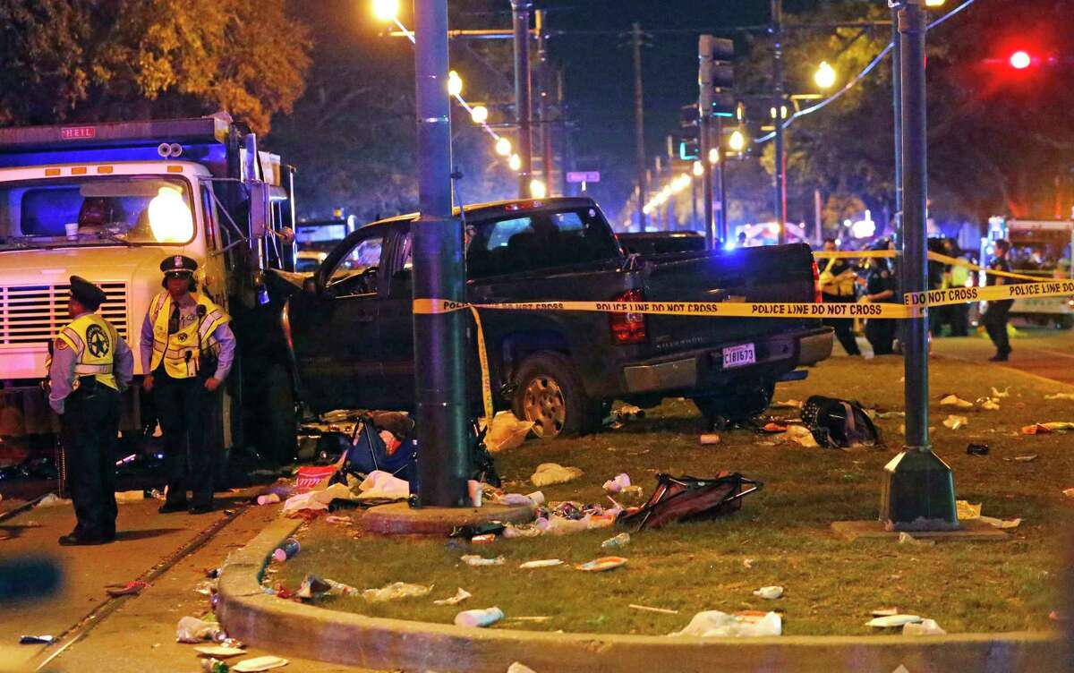 Police stand next to a pickup ﻿that plowed into a crowd and other vehicles Saturday, causing multiple injuries﻿ during ﻿a Mardi Gras parade in New Orleans﻿﻿.﻿