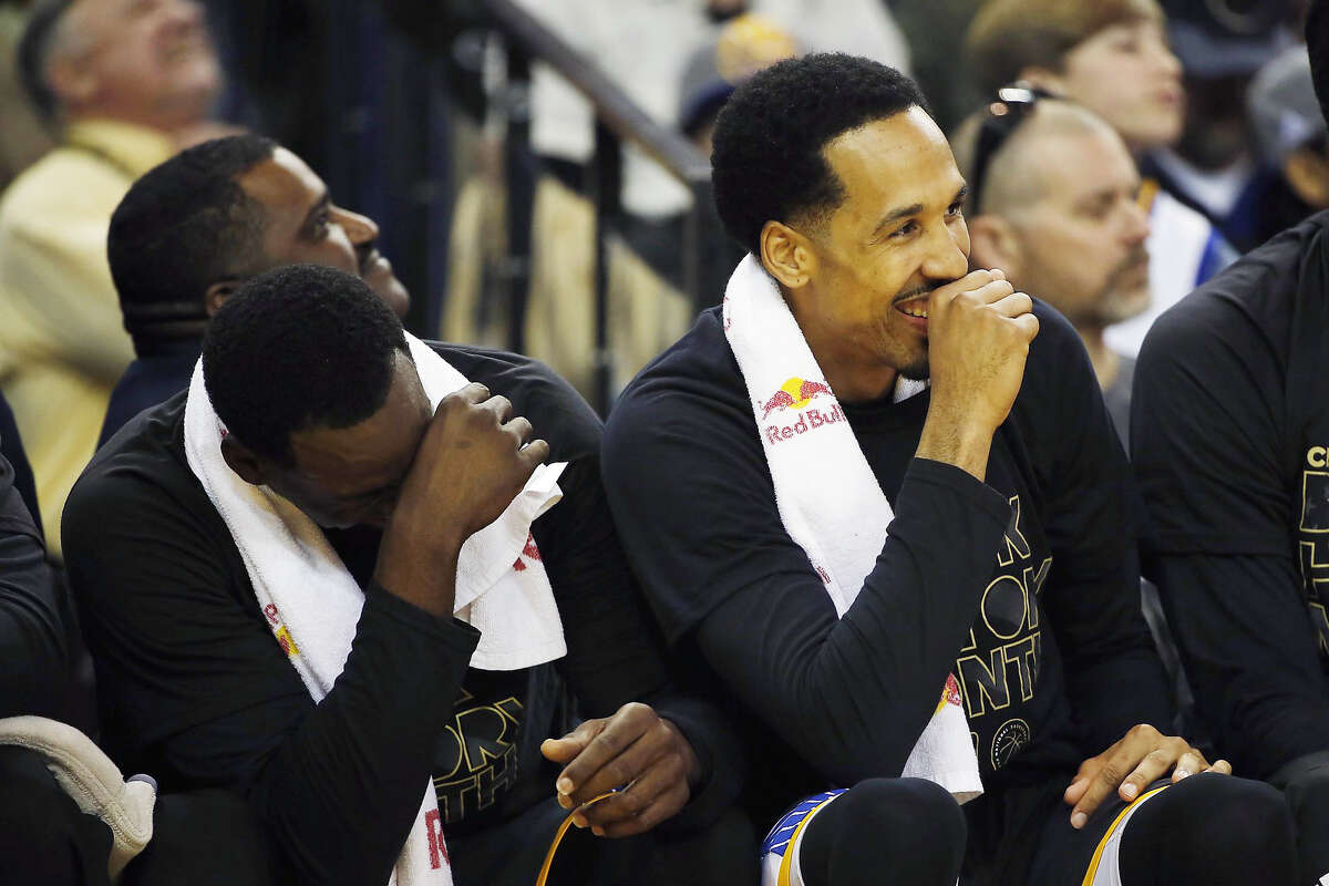 Warriors' Draymond Green and Shaun Livingston laugh on the bench during the second quarter against the Brooklyn Nets at Oracle Arena in Oakland, on February 25, 2017.