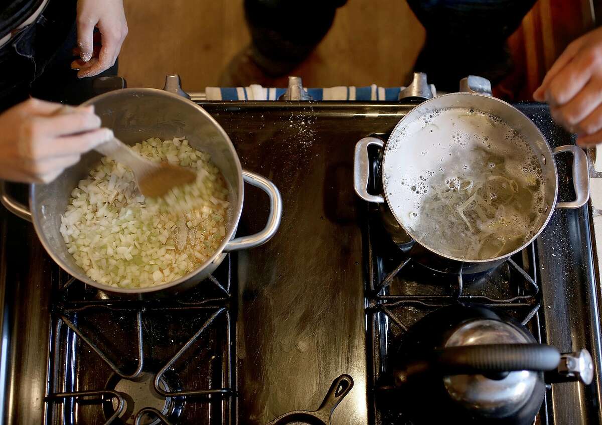 Noodle innovator Ken Albala has cut celery and onions in soup base as he boilsr noodles showing how to make okra noodle soup at home on Friday, February 24, 2017, in Stockton, Calif.