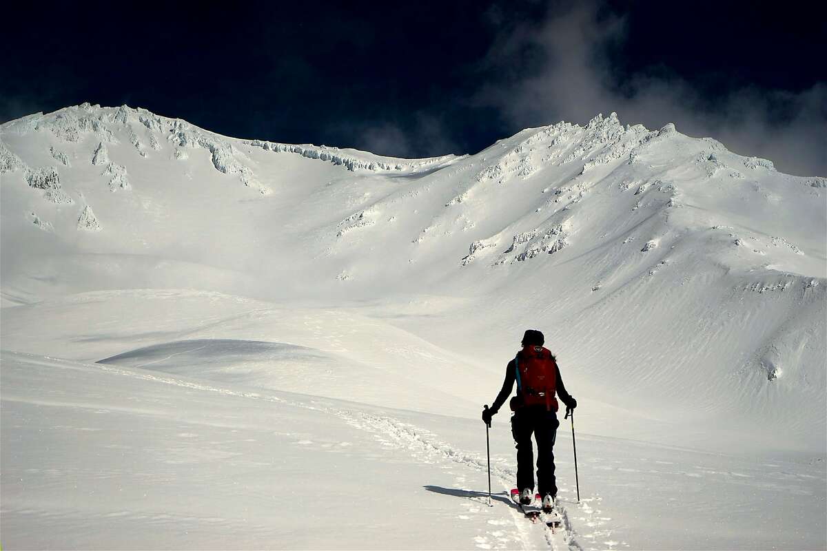 On cross-country skis, Jenn Carr ventures on the moraines at the foot of Avalanche Gulch at Mount Shasta in Northern California