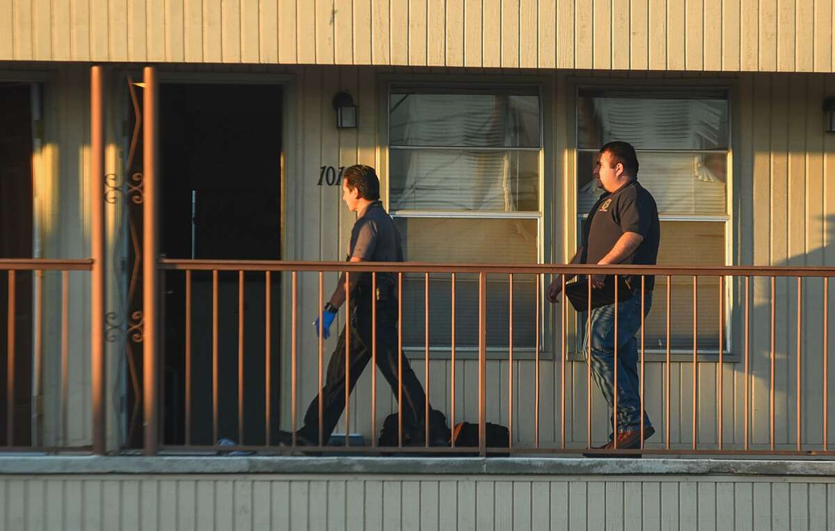 Laredo Police officers look into an apartment where a dead body was found along with signs of arson Saturday on the 2700 block of East Montgomery Street.