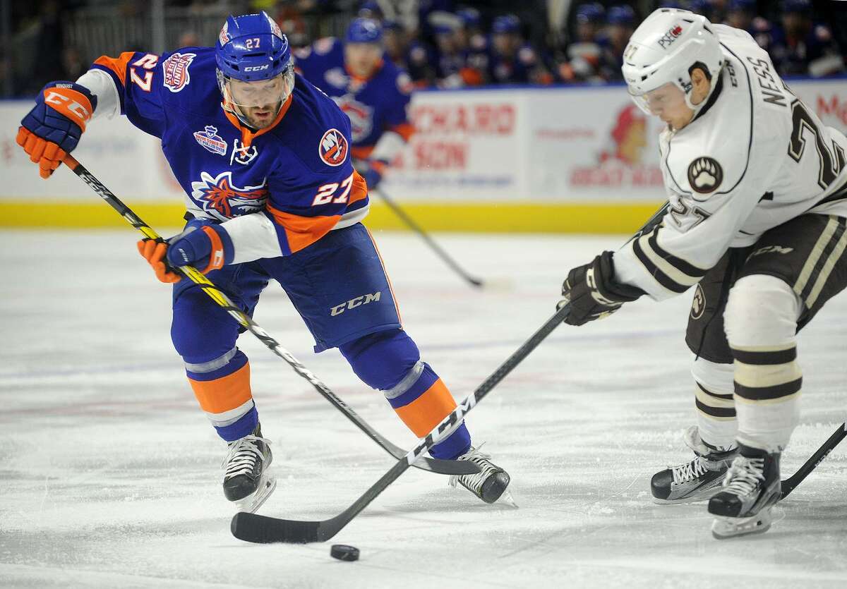 Josh Winquist of the Sound Tigers battles for the puck during the first period of Sunday’s game against the Hershey Bears at the Webster Bank Arena in Bridgeport.