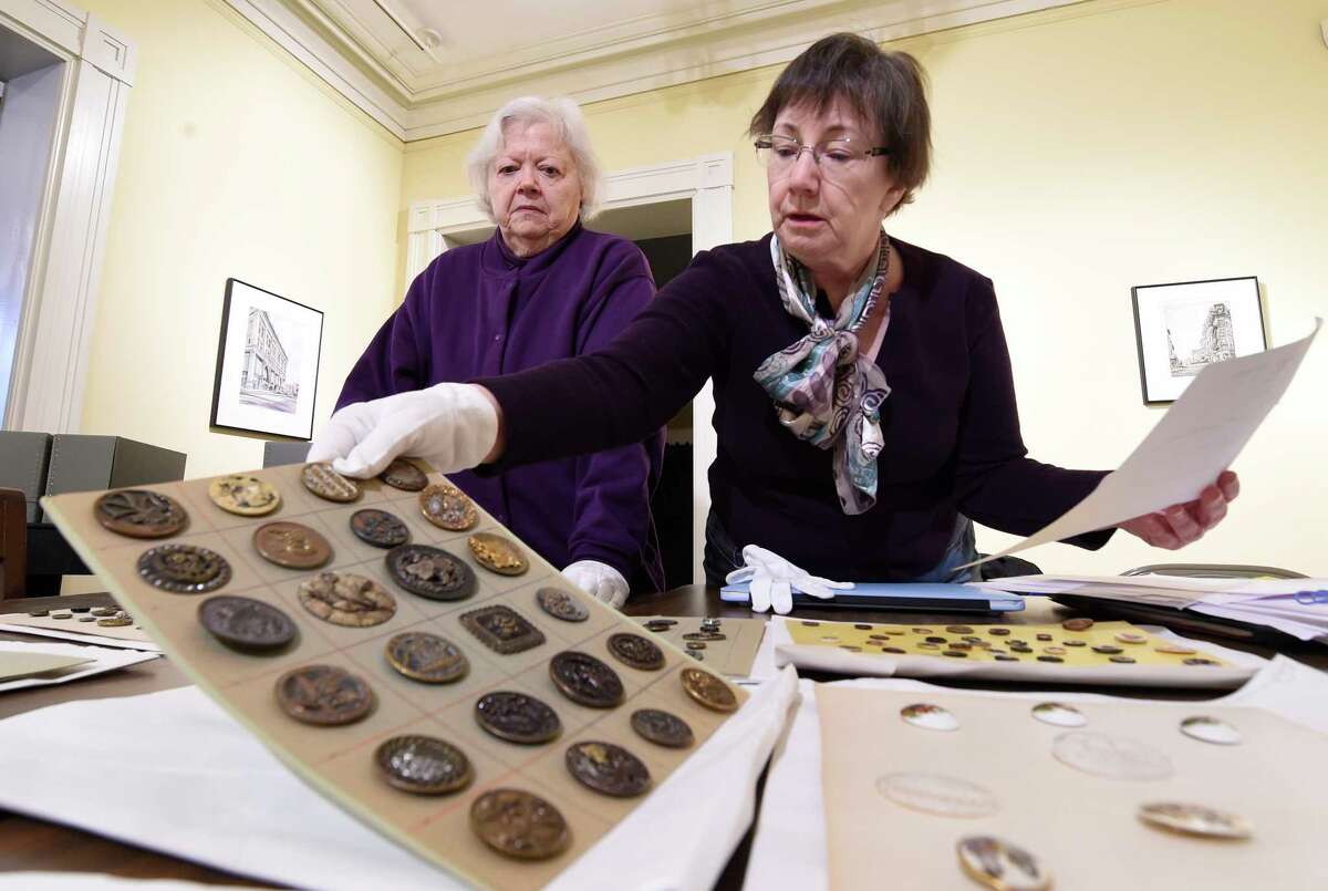 Antique buttons are check for their quality of preservation and their intrinsic value at the Rensselaer County Historical Society Wednesday Feb. 22, 2017 in Troy, N.Y. (Skip Dickstein/Times Union)