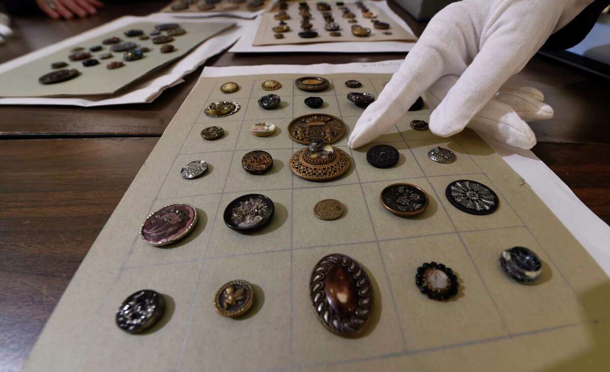 Antique buttons are check for their quality of preservation and their intrinsic value at the Rensselaer County Historical Society Wednesday Feb. 22, 2017 in Troy, N.Y. (Skip Dickstein/Times Union)