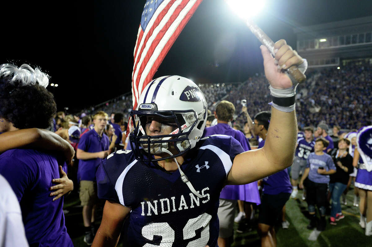 Port Neches-Groves' Logan LeJeune carries the American flag after they beat Nederland in the Mid-County Madness rivalry at The Reservation on Friday evening. PN-G won 41-21. Photo taken Friday 11/4/16 Ryan Pelham/The Enterprise
