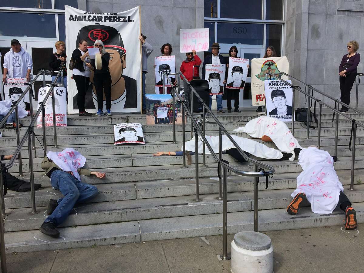 Activists stage a die-in at San Francisco's Hall of Justice on Monday, Feb. 27, 2017, in honor of the two-year anniversary of Amilcar Perez-Lopez's death. Perez-Lopez, 21, was fatally shot by two San Francisco police officers in the Mission District on Feb. 26, 2015.