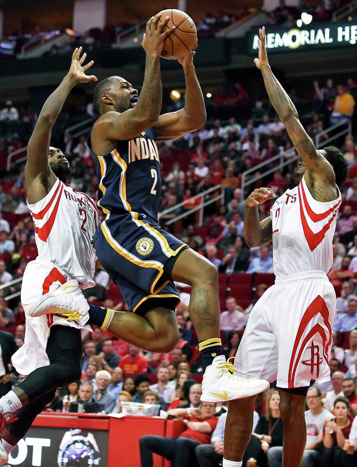 Indiana Pacers guard Rodney Stuckey, center, drives to the basket as Houston Rockets guard Patrick Beverley, left, and guard Louis Williams defend in the first half of an NBA basketball game, Monday, Feb. 27, 2017, in Houston. (AP Photo/Eric Christian Smith)