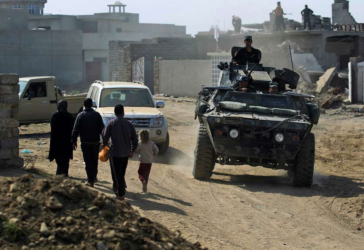 Iraqi forces patrol a street in Mosul's Jawasaq neighbourhood on February 28, 2017, during an offensive to retake the city from Islamic State (IS) group fighters. Hundreds of civilians fled through the desert to escape fighting and privation in Mosul, joining thousands of others who left their homes as conditions worsen in the city's west. / AFP PHOTO / AHMAD AL-RUBAYEAHMAD AL-RUBAYE/AFP/Getty Images