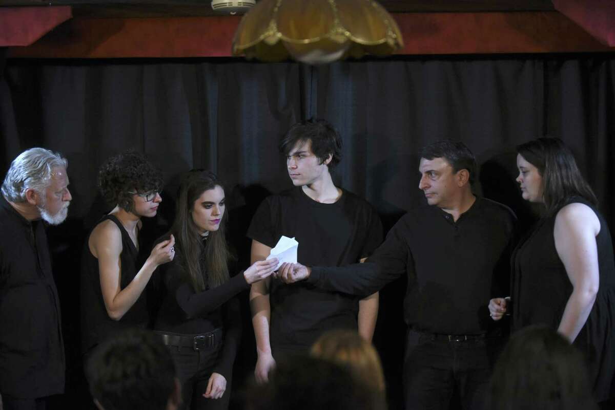 LC Wilks, left, Casey Lynn, Gina Hughes, George Velez Cue, Scott Leibowitz and Tina Jackson read a list of audience suggestions onstage prior to their performance of “After Life,” an improvised drama being produced by Alamo City Improv at the Magic Time Machine.