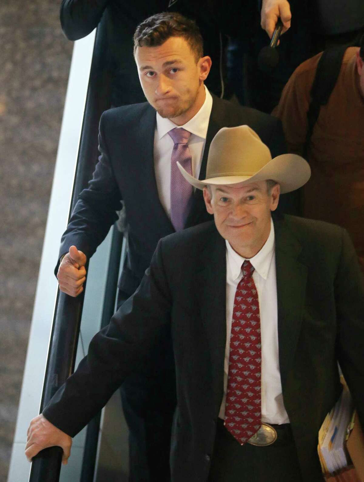 Former NFL quarterback Johnny Manziel, left, leaves a courthouse with his lawyer Jim Darnell after a hearing in Dallas, Tuesday, Feb. 28, 2017. A Dallas County judge ordered Manziel to be at the hearing to address concerned about reports that he has violated terms of a plea agreement for a domestic violence case. (AP Photo/LM Otero)