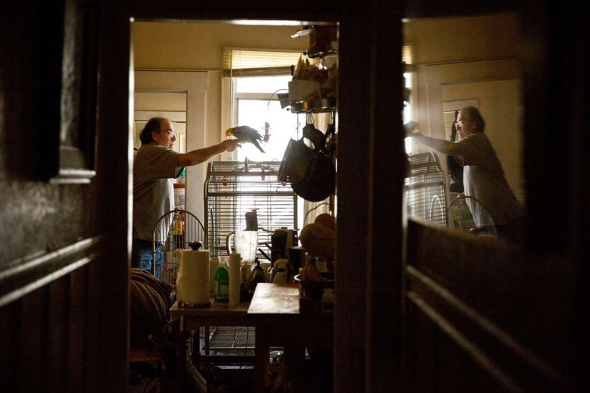 From left: Mike Reed and his bird Wheezy at his home on Tuesday, Feb. 28, 2017, in San Francisco, Calif. Reed, the landlord, rents an apartment out to a tenant with a Section 8 voucher from the S.F. Housing Authority.