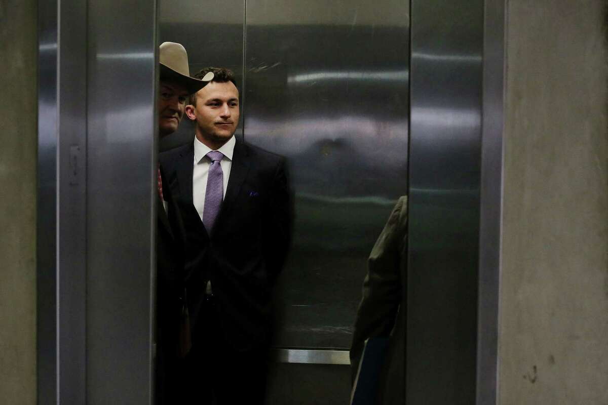 Former Texas A&M quarterback Johnny Manziel and defense attorney Jim Darnell enter an elevator in a parking structure following a hearing with judge Roberto Canas in Dallas County criminal court 10 at the Frank Crowley Courts Building in Dallas February 28, 2017. Manziel is in a hearing following an agreement reached with the county regarding his misdemeanor domestic violence case. (Andy Jacobsohn/The Dallas Morning News)