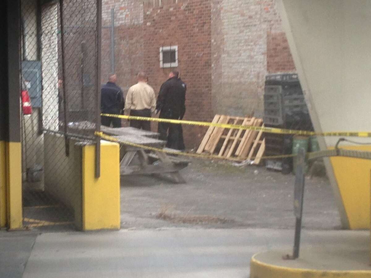 Schenectady police are investigating discovery of man's body found about 2:30 p.m. Tuesday next to a parking garage near an Italian bakery in the 200 block of Broadway. (Paul Nelson / Times Union)