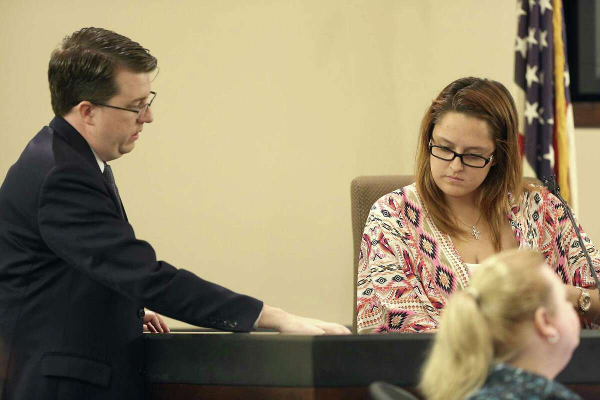 Prosecutor Ryan Wright, left, goes over a document Tuesday, Feb. 28, 2017, with witness Serena Fullerton in 187th state District Court, presided by Judge Steven Hilbig, during the trial of former San Antonio Police officers Alejandro Chapa and Emmanuel Galindo. The former officers are on trial for charges of compelling prostitution, accused of recruiting and duping the women into having sex with them.