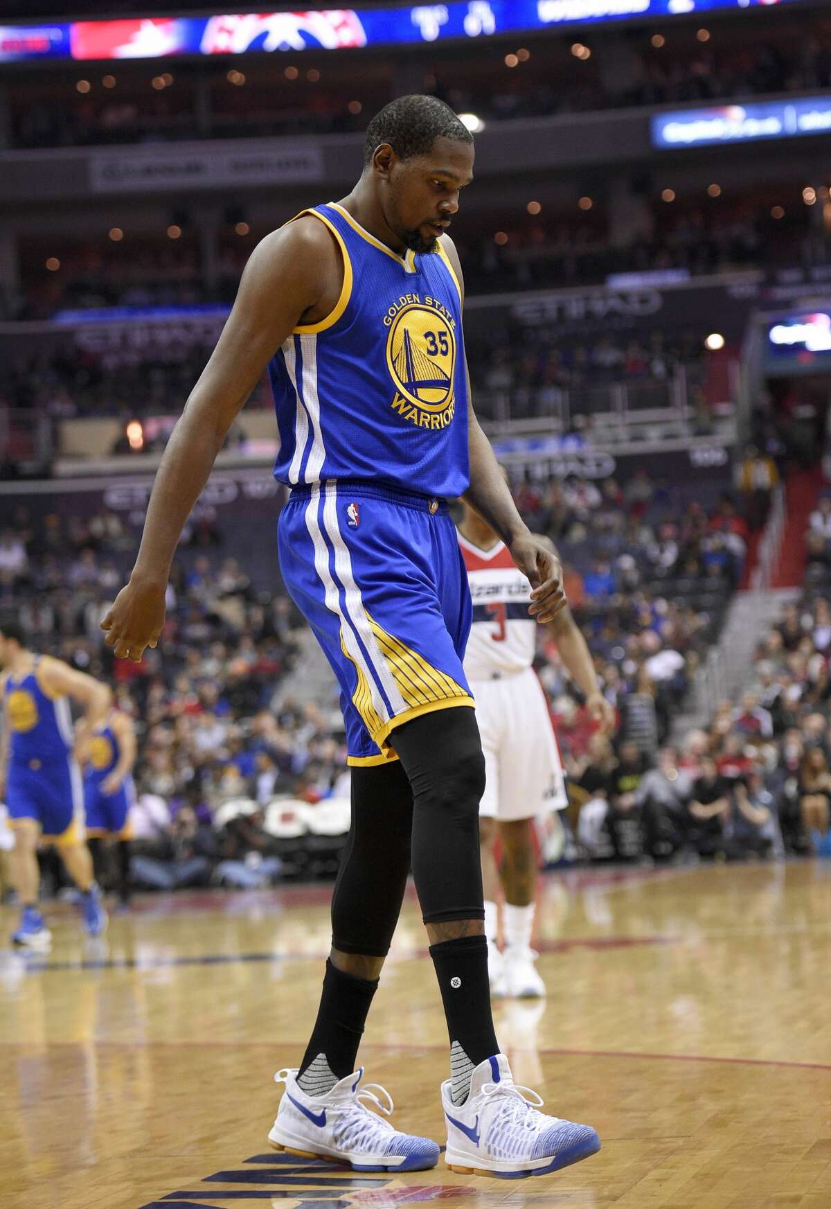 Golden State Warriors forward Kevin Durant (35) walks to the bench during the first half of an NBA basketball game against the Washington Wizards, Tuesday, Feb. 28, 2017, in Washington. Durant hyperextended his left knee and exited the Golden State Warriors' game at the Washington Wizards for good after all of 93 seconds Tuesday night. (AP Photo/Nick Wass)