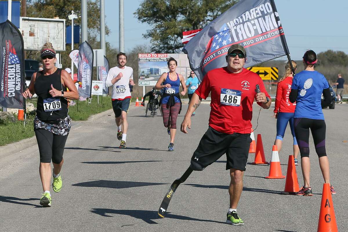 Army Staff Sgt. Cahin Perez (right) approaches the finish line with Lisa Short (left) during Operation Comfort's 7th Annual Salute to Service Members 5K Feb. 25 at Blue Bonnet Palace in Schertz. Perez took second place in the adaptive ambulatory division with a time of 29.28 seconds. Three hundred seventy people participated in the race benefiting Operation Comfort, a non-profit organization founded to support the needs of wounded, ill and injured service members receiving treatment at San Antonio Military Medical Center and Audie Murphy Memorial VA Hospital. MARVIN PFEIFFER/ mpfeiffer@express-news.net