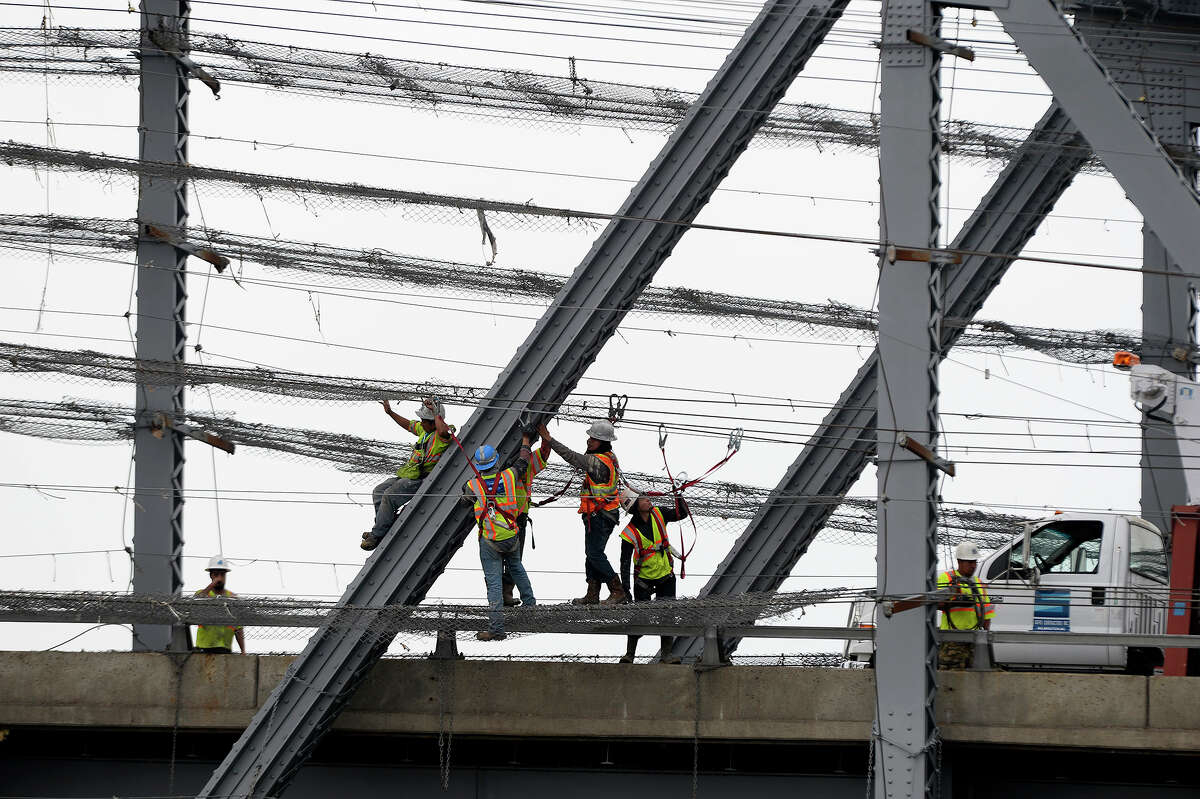 Workers on the Rainbow Bridge between Port Arthur and Bridge City on Wednesday. A worker was injured after falling on the bridge, according to Sarah Dupre with TxDOT, but she did not have more information. Photo taken Wednesday 3/1/17 Ryan Pelham/The Enterprise